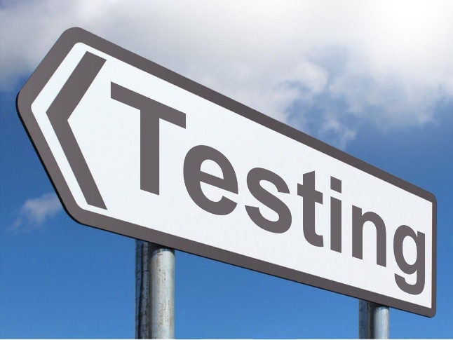  Large sign that says "Testing" with sky in the background. 